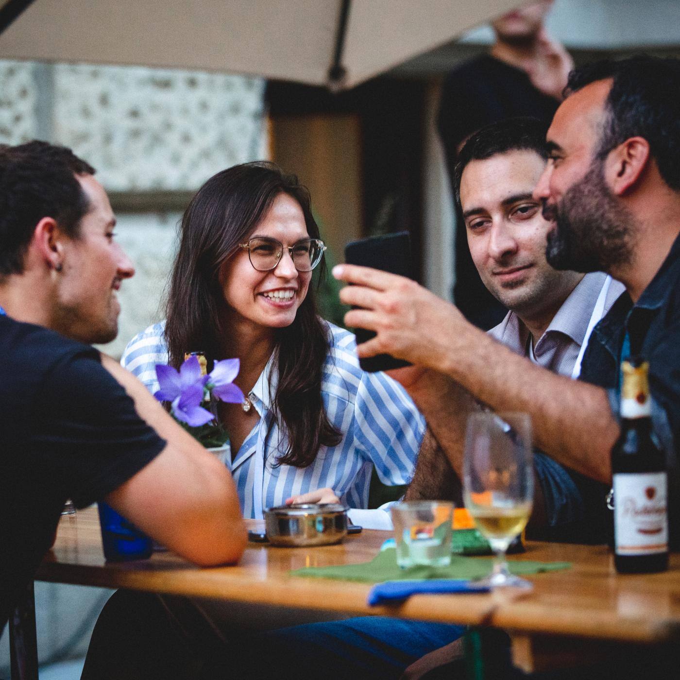 group of people sitting at a table laughing