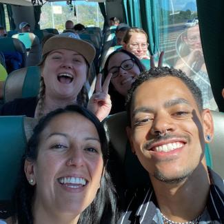 people in a bus smiling in a selfie