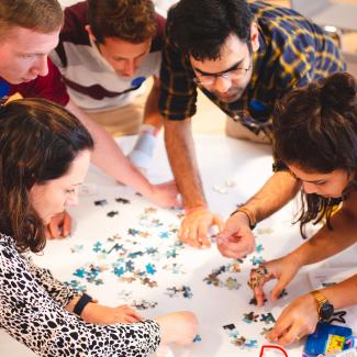 group of people doing a puzzle